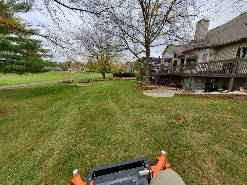 Freshly mowed backyard lawn near a wood deck