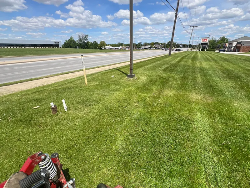 Striped lawn on a large property being mowed by an Autana crew