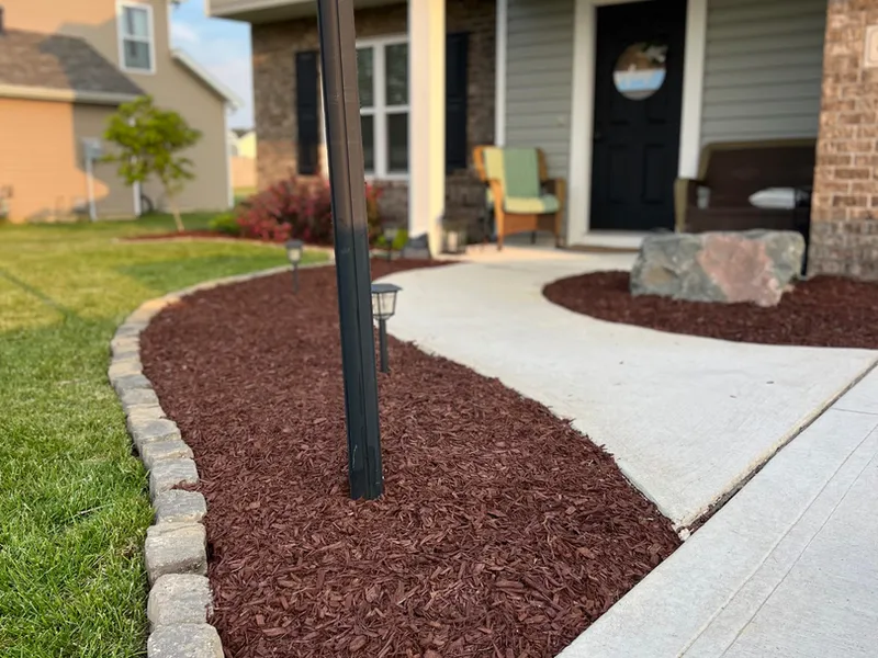 Red mulch bed along a front walkway