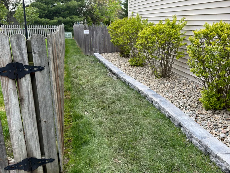 White rock drainage strip running along a fence line